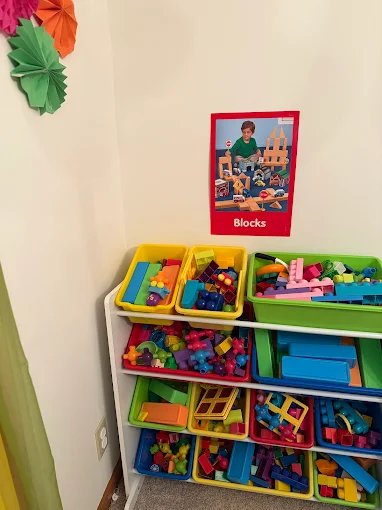Child with pig inflatable during playful moments at Graceland Kids Center